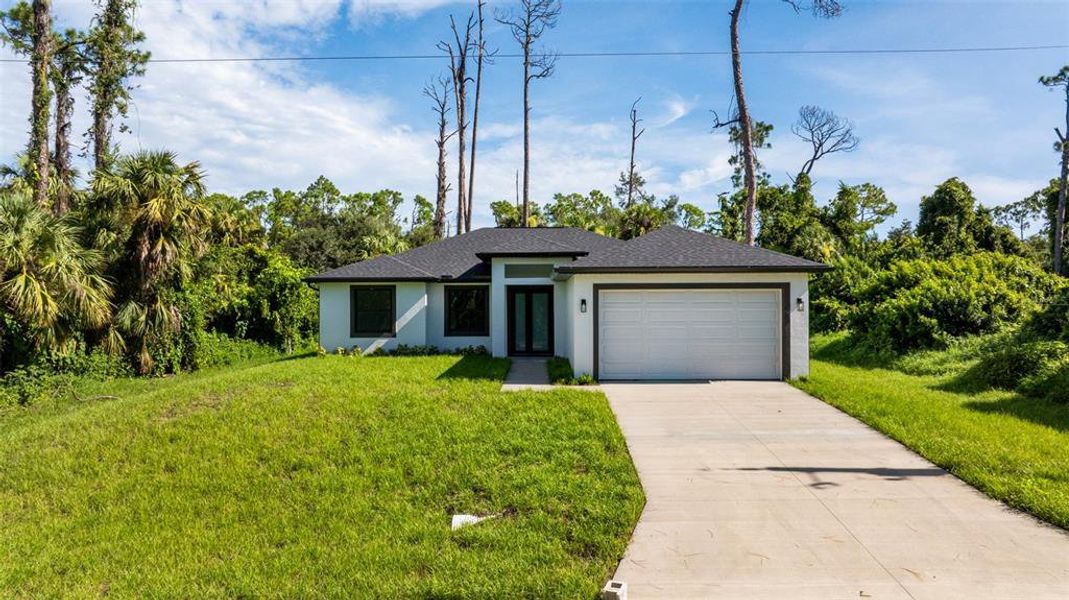 Front exterior of a new home in , Port Charlotte, FL, highlighting curb appeal (Image 1).