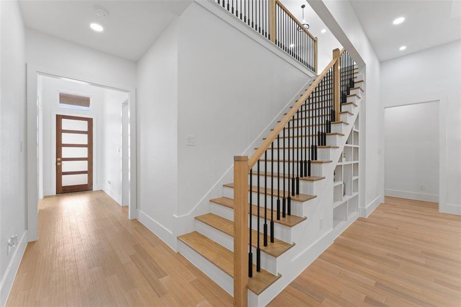 Foyer featuring recessed lighting, light wood-style flooring, and stairway