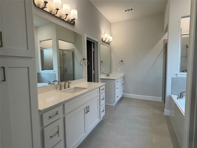 Bathroom featuring vanity, separate shower and tub, and tile patterned flooring