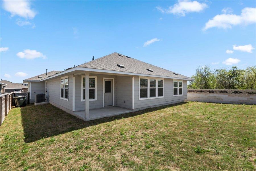 Back of property with a patio area, a fenced backyard, and a shingled roof