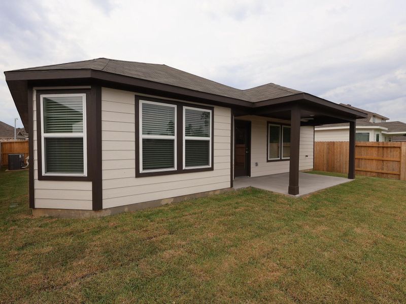 Front exterior of a new home in Pinewood at Grand Texas, New Caney, TX, highlighting curb appeal (Image 2). Front exterior of a new home in Pinewood at Grand Texas, New Caney, TX, highlighting curb appeal (Image 2).