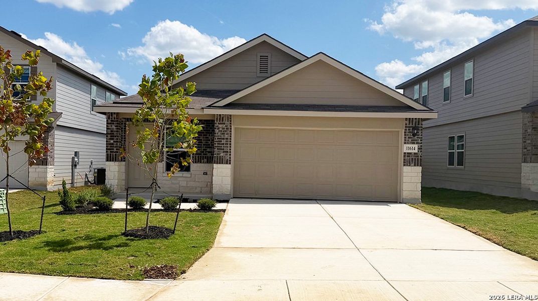 Front exterior of a new home in Laurel Vistas, San Antonio, TX, highlighting curb appeal (Image 2). Front exterior of a new home in Laurel Vistas, San Antonio, TX, highlighting curb appeal (Image 2).