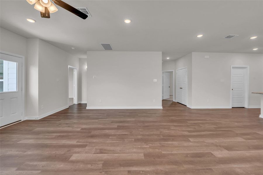 Unfurnished living room with recessed lighting, light wood-style floors, and a ceiling fan Unfurnished living room with recessed lighting, light wood-style floors, and a ceiling fan