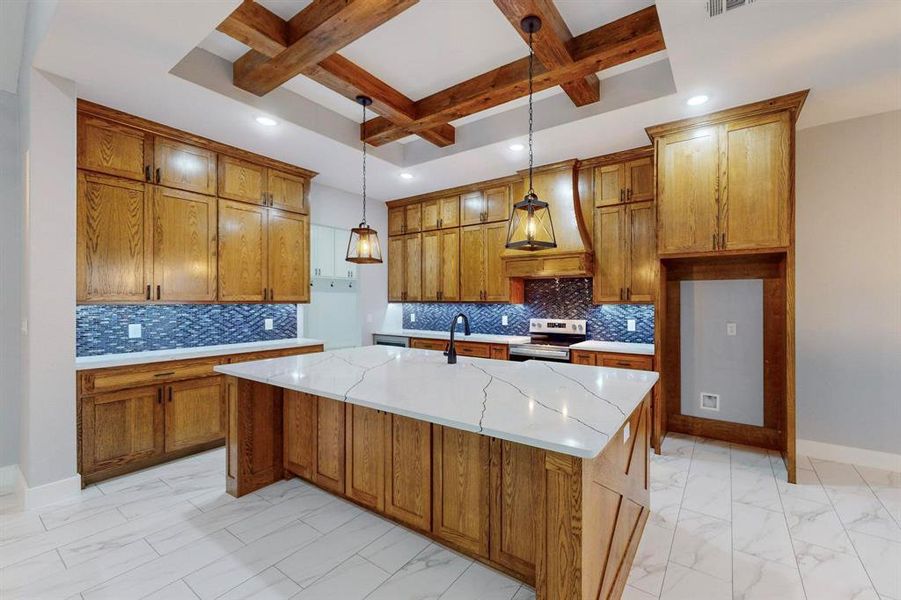 Kitchen with tasteful backsplash, a center island with sink, pendant lighting, beamed ceiling, and stainless steel electric stove