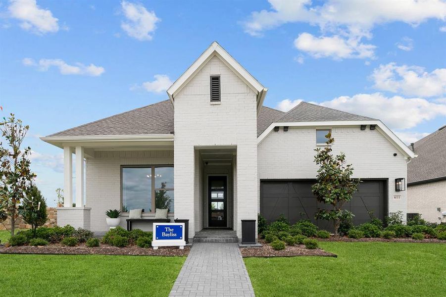 View of front facade featuring brick siding, a front lawn, roof with shingles, and covered porch View of front facade featuring brick siding, a front lawn, roof with shingles, and covered porch