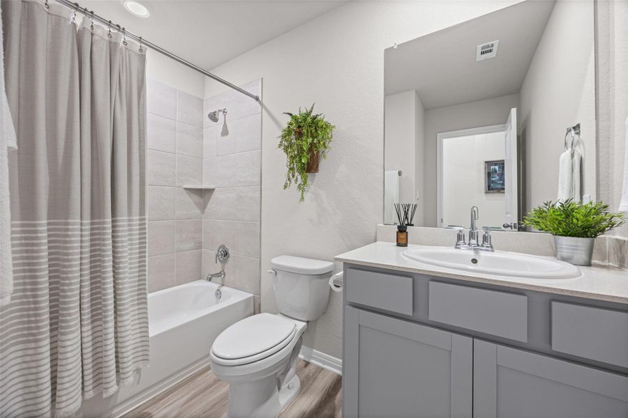 Clean lines and a modern vanity define this elegant full bathroom.