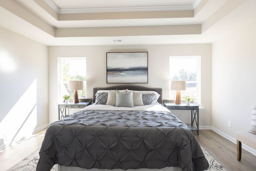 Primary bedroom features large windows, inviting in natural light