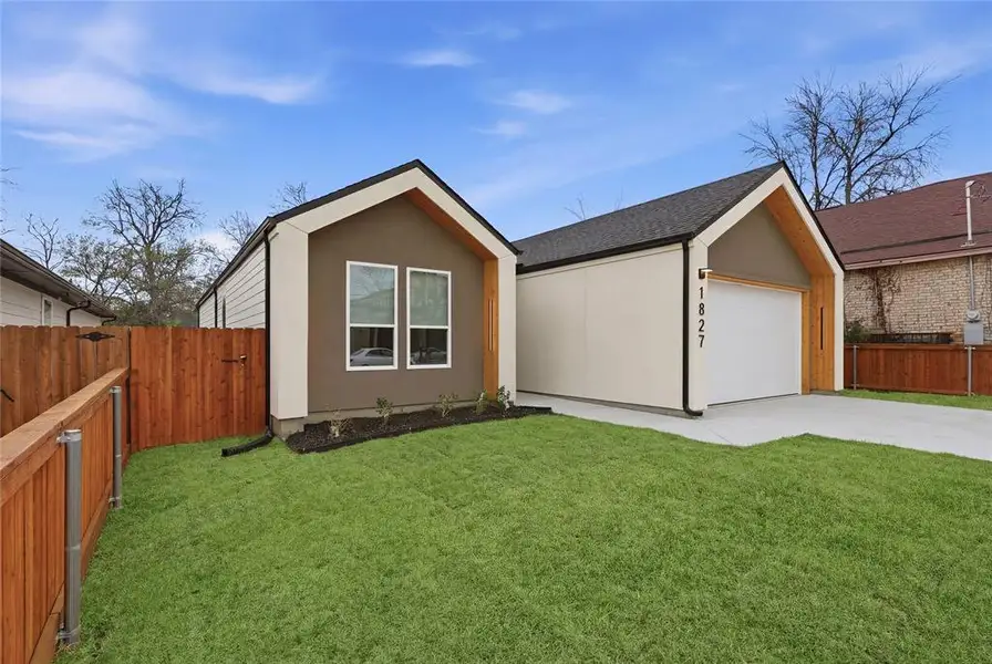 View of front facade featuring a garage, concrete driveway, roof with shingles, and stucco siding View of front facade featuring a garage, concrete driveway, roof with shingles, and stucco siding