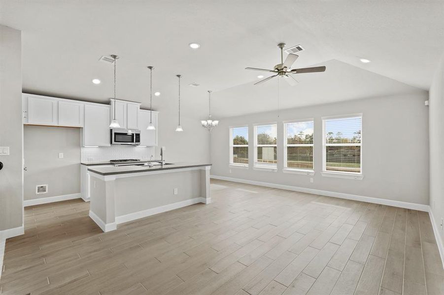 Open great room, kitchen and dining with wall of windows for lots of natural light.  (*Photo not of actual home and used for illustration purposes only.)