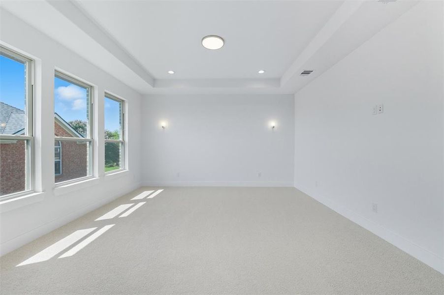 Unfurnished room with a tray ceiling, carpet, and recessed lighting