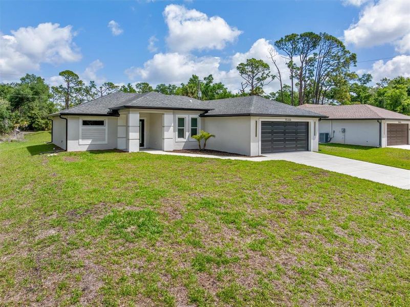 Front exterior of a new home in , Port Charlotte, FL, highlighting curb appeal (Image 14).