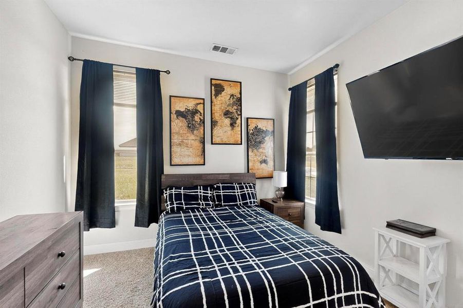 Bedroom with light carpet and baseboards Bedroom with light carpet and baseboards