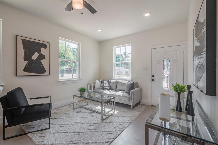 Living room featuring ceiling fan and light hardwood / wood-style floors