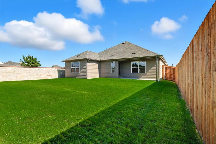 Back of property featuring a patio area, a fenced backyard, and roof with shingles