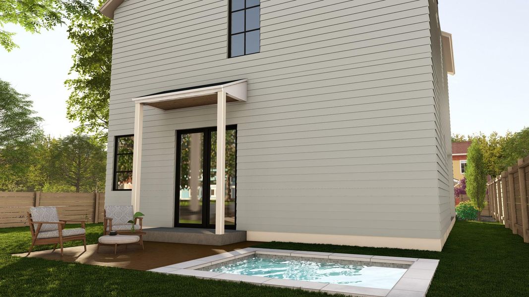 Rear view of house featuring a hot tub and a patio area