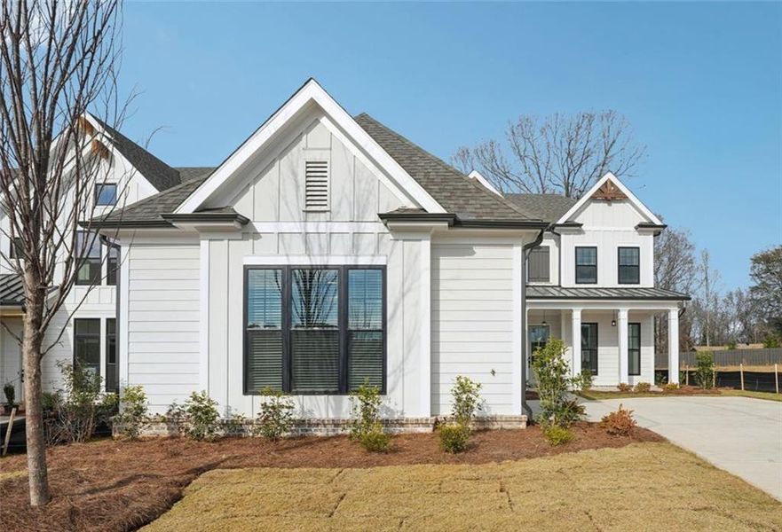 Front exterior of a new home in Promenade at Sawnee Village, Cumming, GA, highlighting curb appeal (Image 1). Front exterior of a new home in Promenade at Sawnee Village, Cumming, GA, highlighting curb appeal (Image 1).
