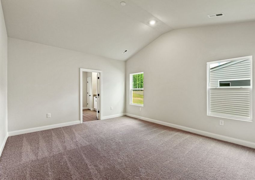 The master bedroom has lots of windows to let in natural light