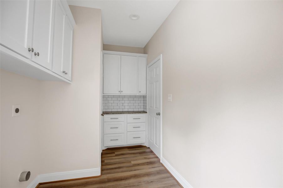 Massive utility room! You will love organizing your family before they come into the main living area! Those cabinets and drawers are perfect!