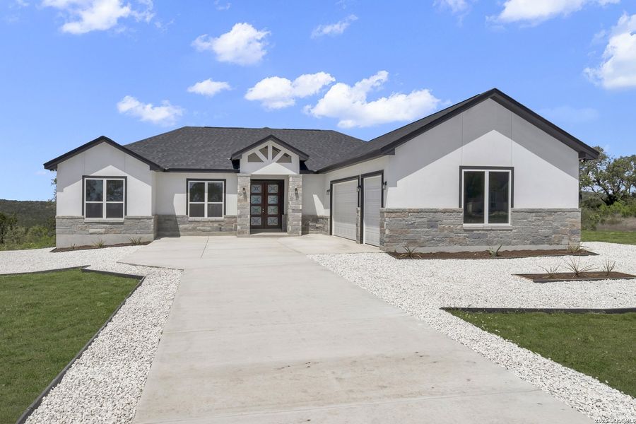 Front exterior of a new home in , Mico, TX, highlighting curb appeal (Image 6).
