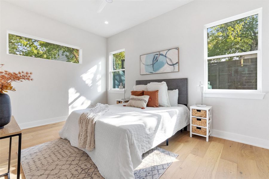 Bedroom featuring light wood-type flooring and recessed lighting Bedroom featuring light wood-type flooring and recessed lighting