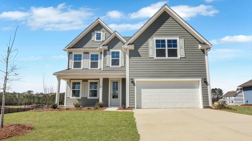 Front exterior of a new home in Berkeley Bay, Ridgeville, SC, highlighting curb appeal (Image 1). Front exterior of a new home in Berkeley Bay, Ridgeville, SC, highlighting curb appeal (Image 1).