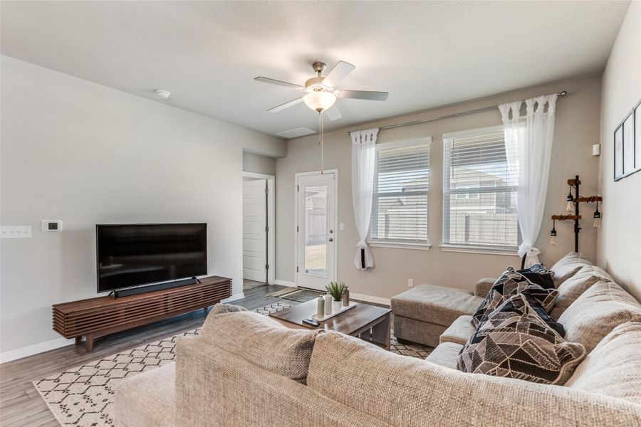 Living area featuring wood finished floors and ceiling fan