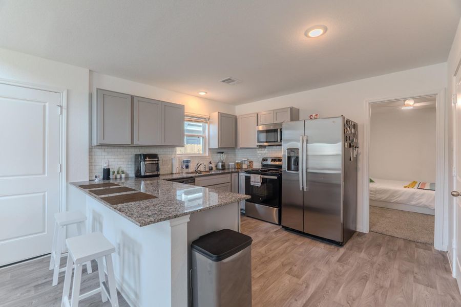 Upgraded kitchen with quartz countertops and modern fixtures Upgraded kitchen with quartz countertops and modern fixtures