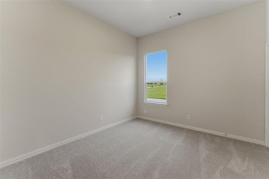 Room featuring neutral wall paint, gray carpeting, a single window, white baseboards, and a ceiling vent