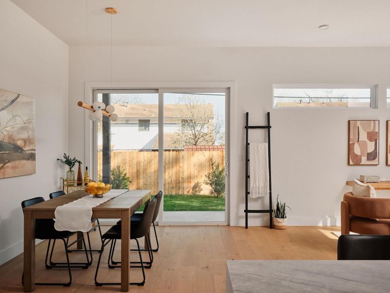 Dining space featuring light wood-style flooring and baseboards