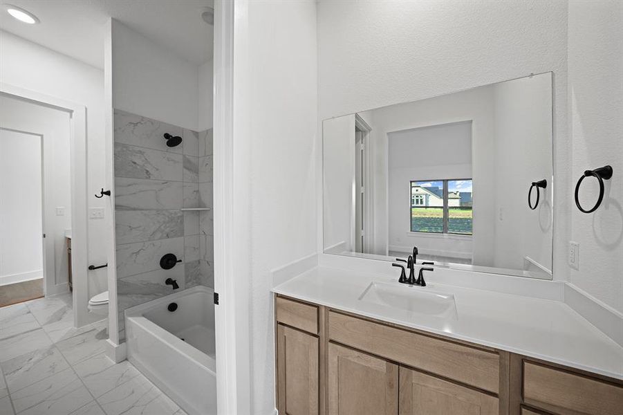 Full bath with shower / washtub combination, light marble finish floors, and vanity Full bath with shower / washtub combination, light marble finish floors, and vanity