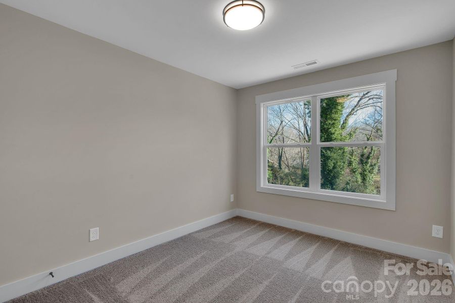 Bedroom 2 -  sunlit and inviting, this bedroom combines comfort with thoughtful storage