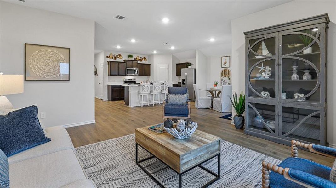 Living area with light wood finished floors and recessed lighting Living area with light wood finished floors and recessed lighting