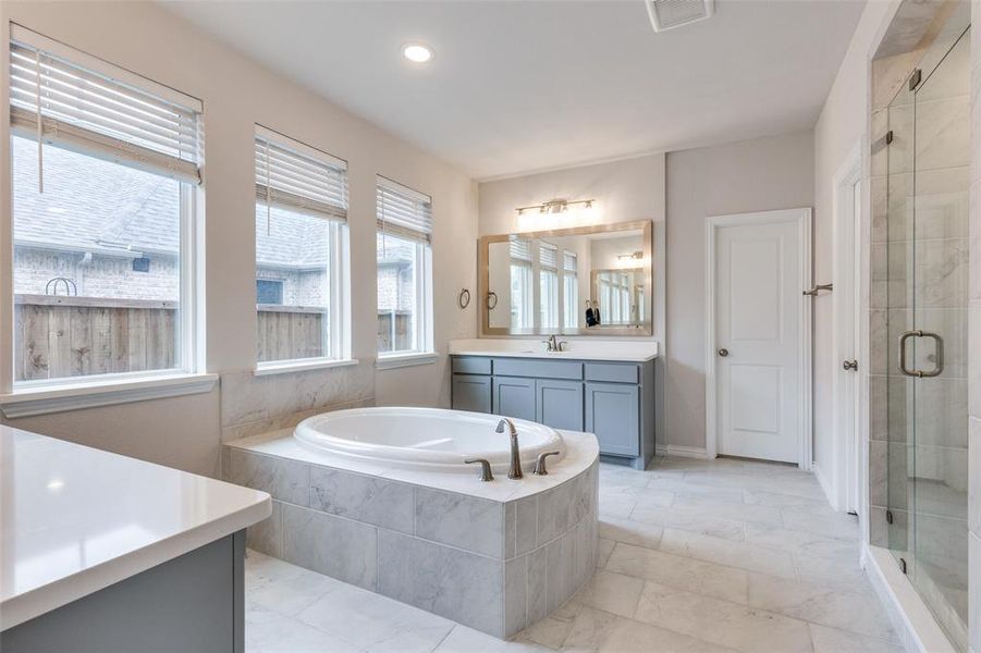 Bathroom featuring plus walk in shower and vanity