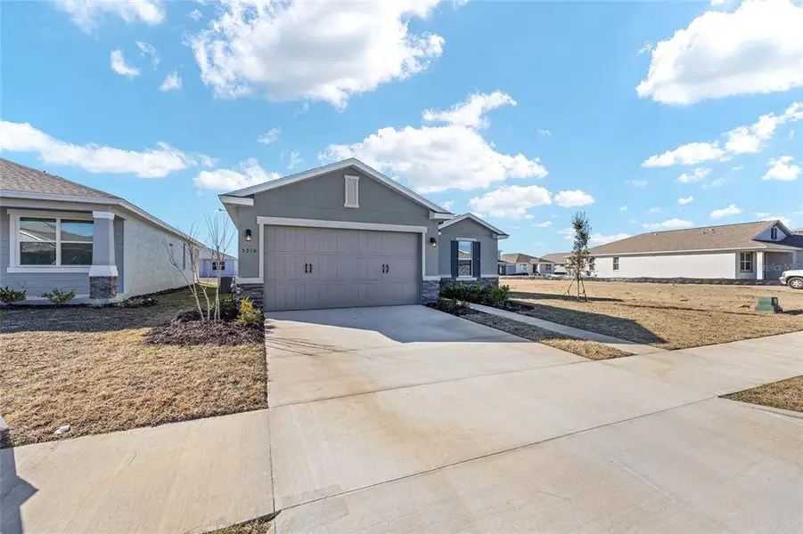 Front exterior of a new home in Calesa Township, Ocala, FL, highlighting curb appeal (Image 21).