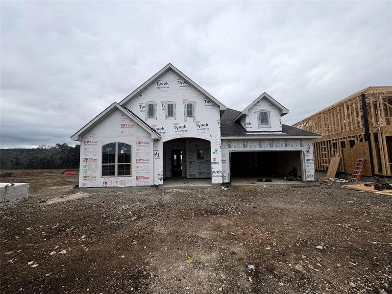 Unfinished property with a garage and driveway Unfinished property with a garage and driveway