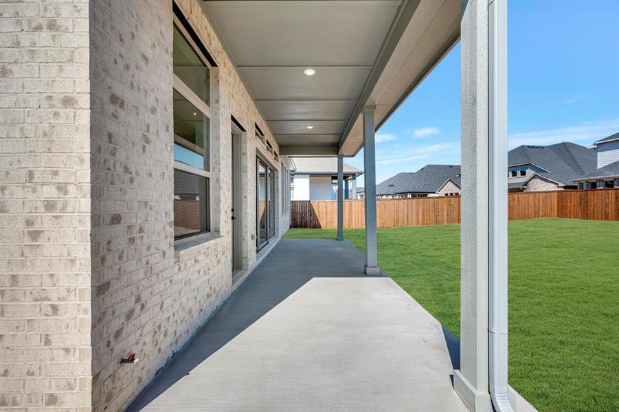 Fenced backyard with a patio
