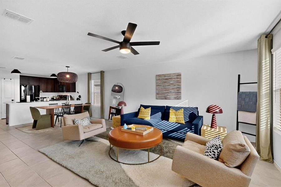 Living area with light tile patterned floors and a ceiling fan Living area with light tile patterned floors and a ceiling fan