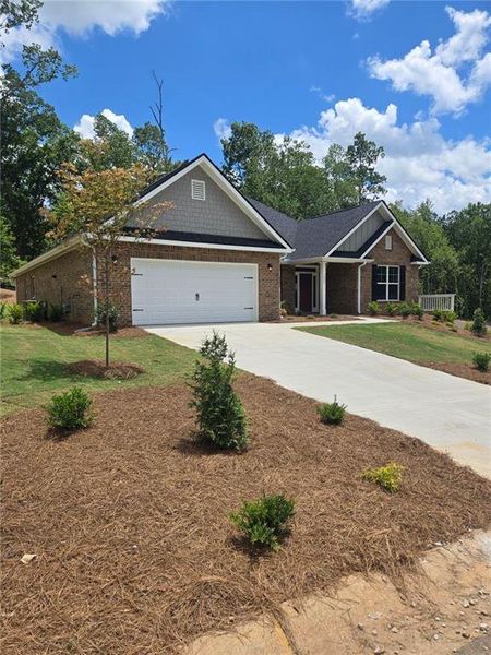 Front exterior of a new home in Mirror Lake at South Harbour, Villa Rica, GA, highlighting curb appeal (Image 1). Front exterior of a new home in Mirror Lake at South Harbour, Villa Rica, GA, highlighting curb appeal (Image 1).