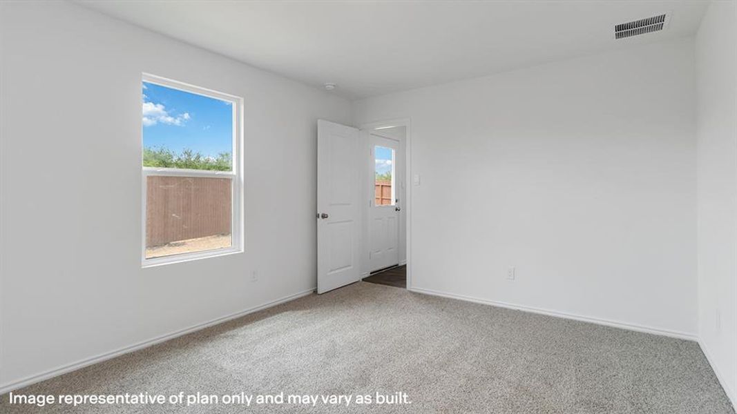 Carpeted empty room featuring baseboards