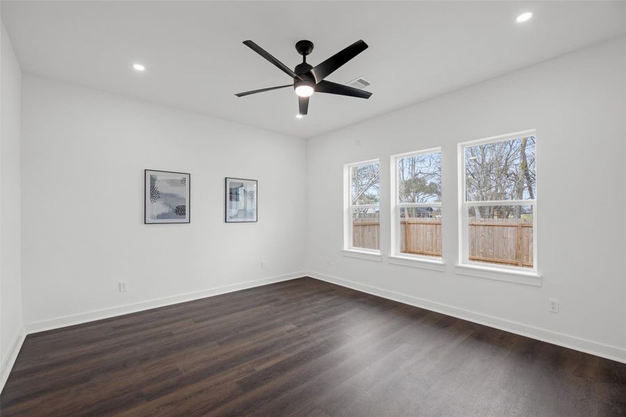 White walls enhance its spacious feel, complemented by minimalist framed art.