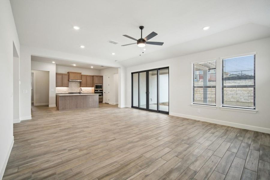 Unfurnished living room featuring baseboards, light wood-style floors, recessed lighting, and a ceiling fan Unfurnished living room featuring baseboards, light wood-style floors, recessed lighting, and a ceiling fan