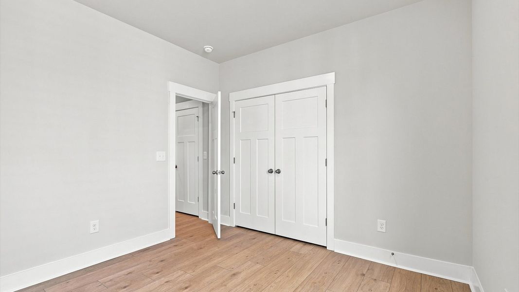 Desirable hardwood flooring in all bedrooms creates a cohesive and elegant interior Desirable hardwood flooring in all bedrooms creates a cohesive and elegant interior