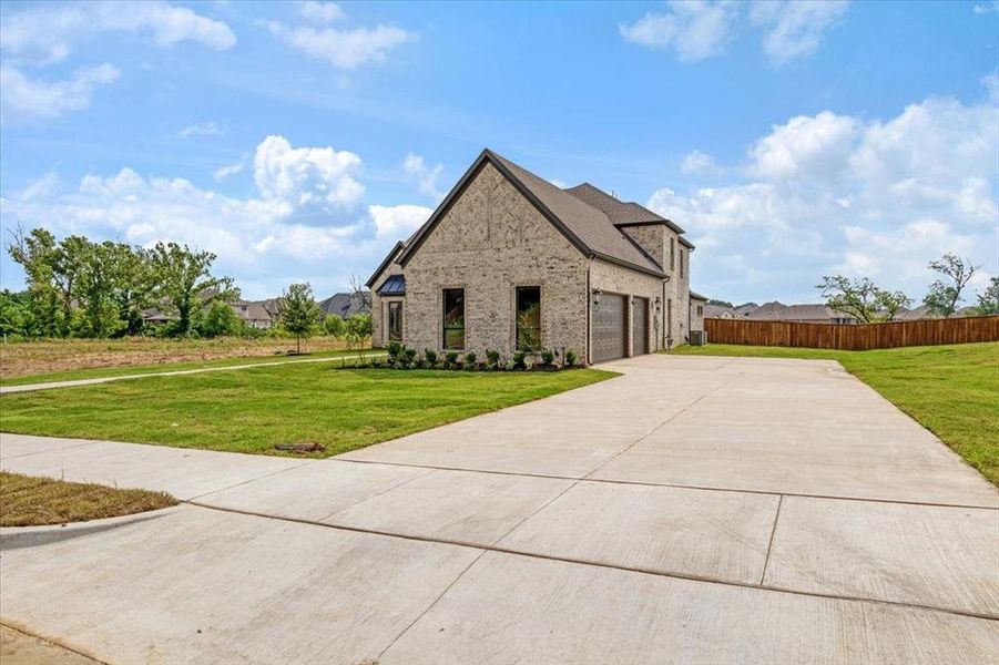 View of front of property with a front lawn and a garage