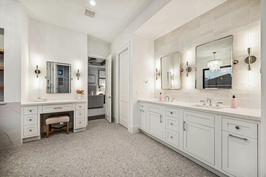 Primary Bath with a 24 x 24 Matte Tile Floor, Inset Shaker Style Cabinetry with Soft Close Drawers and Doors. Slab Quartz Counters, Glazed Tile Backsplash Wall. Dual Rectangle Sinks, Dual Brizo Litze Widespread Faucets finished in Brushed Nickel, Dual Pivot Mirrors with Brushed Nickel Finish. Three 2 Light 4-3/4" Wide Wall Sconce.  Beautiful built-in Vanity and a separate commode area.