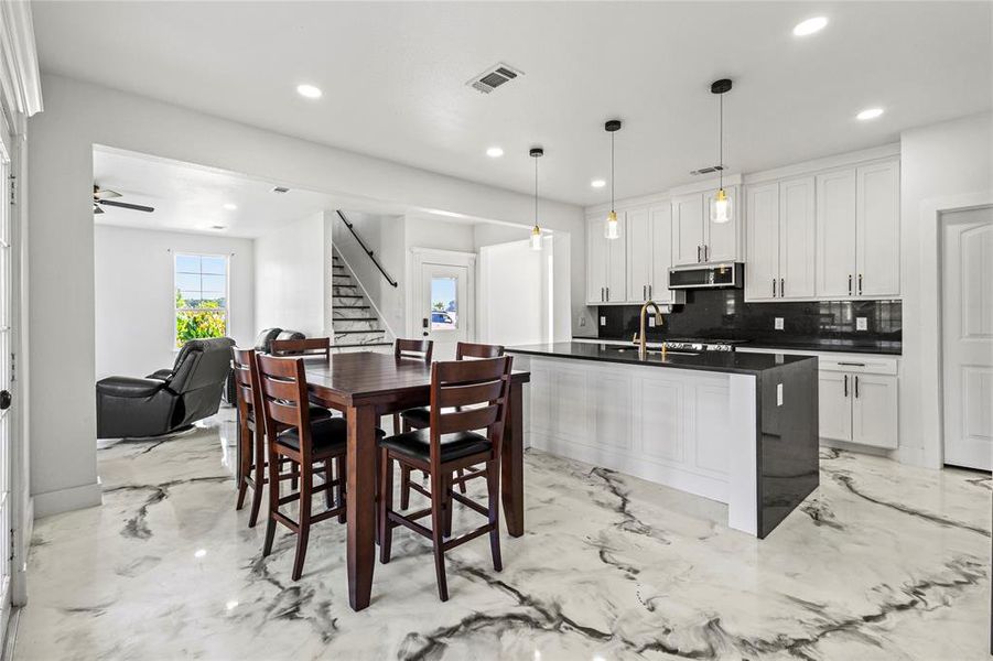 Dining space featuring stairway, light marble finish floors, and recessed lighting Dining space featuring stairway, light marble finish floors, and recessed lighting