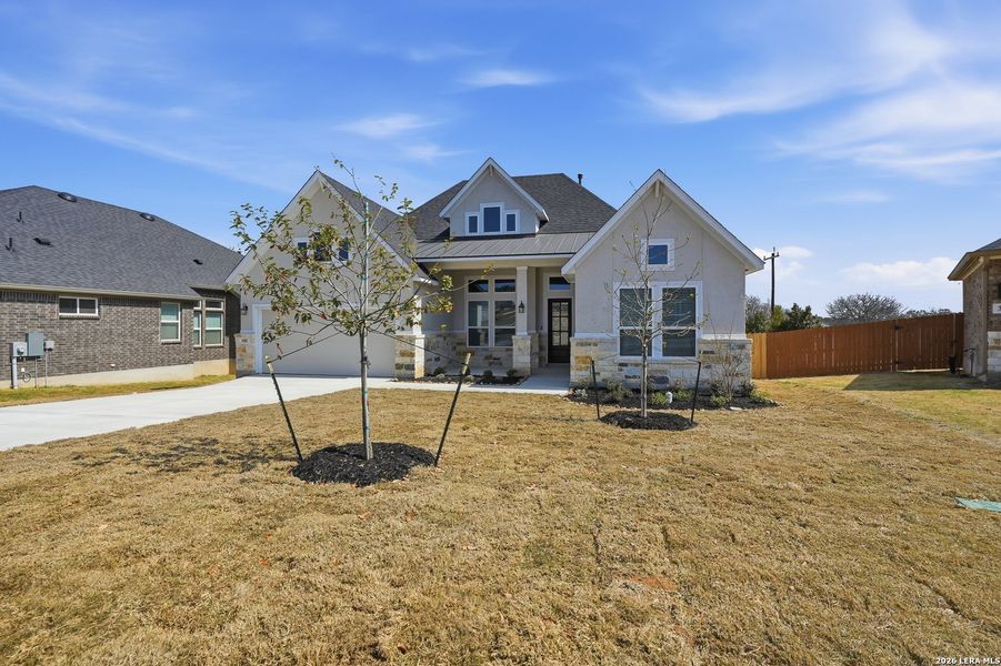 Front exterior of a new home in Potranco Oaks, Castroville, TX, highlighting curb appeal (Image 25).