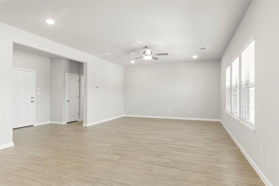 Unfurnished room featuring ceiling fan, recessed lighting, light wood finished floors, and baseboards