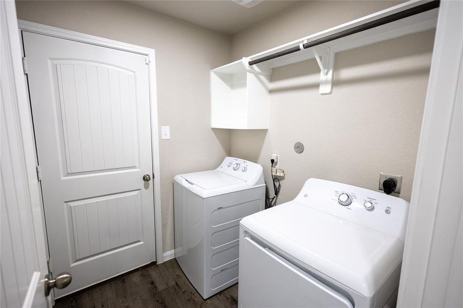 Convenient utility room with washer/dryer connections and direct access to the spacious two-car garage.