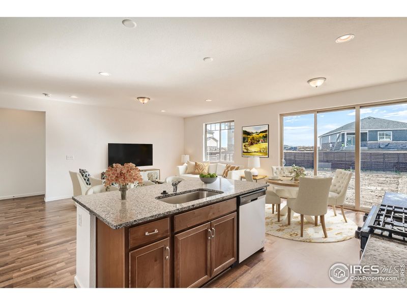 Home Under Construction. Photos are of the same Alpine floorplan, different home. Kitchen, dining and great room Home Under Construction. Photos are of the same Alpine floorplan, different home. Kitchen, dining and great room