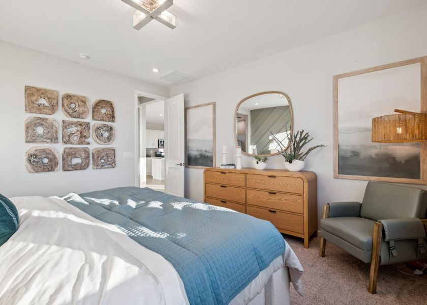 A bedroom with a bed and a chair. A bedroom with a bed and a chair.